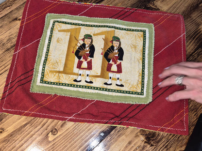 11 pipers piping on handmade, quilted placemat