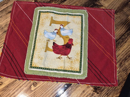 Decorative placemat with a 3 French hens design on a wooden surface