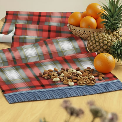 Red, white, grey, gold, and black tartan table runner